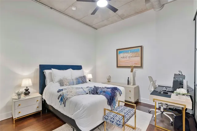 a bedroom with a bed and a chandelier fan