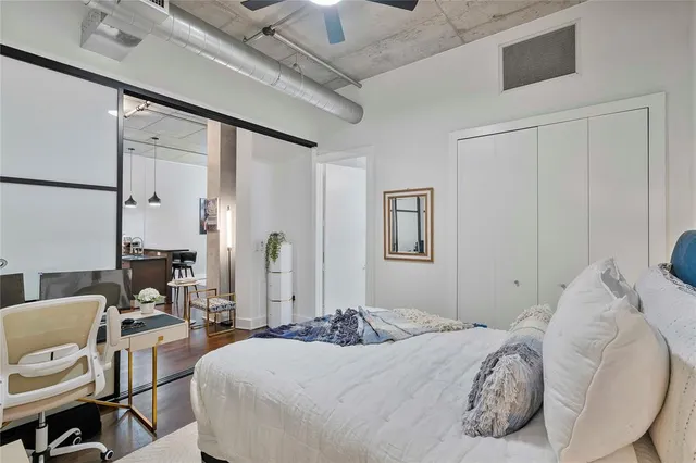 a bedroom with a bed a table and chair