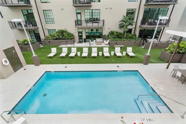 a kitchen with stainless steel appliances kitchen island granite countertop a dining table and chairs