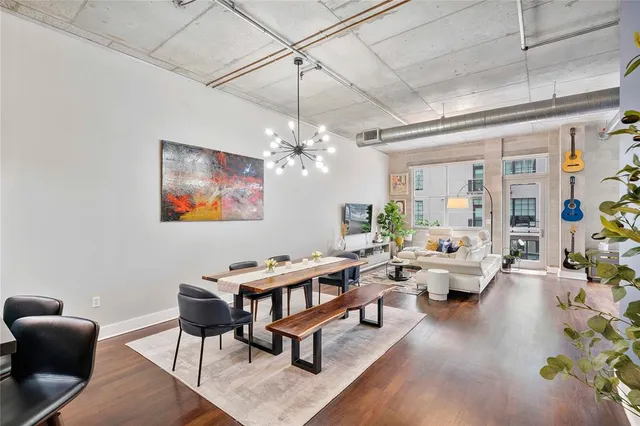a living room with lots of furniture and a chandelier
