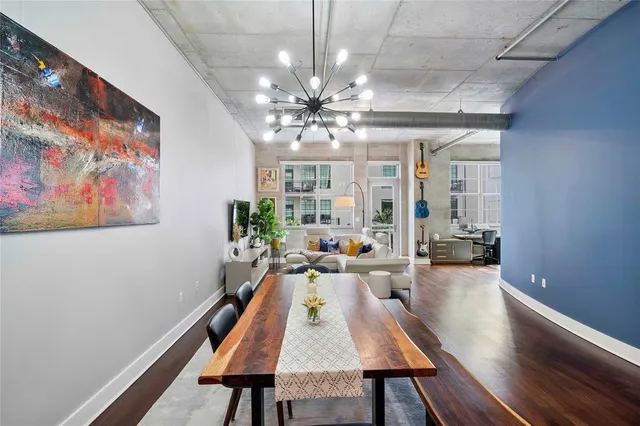 a living room with furniture a chandelier and a large window