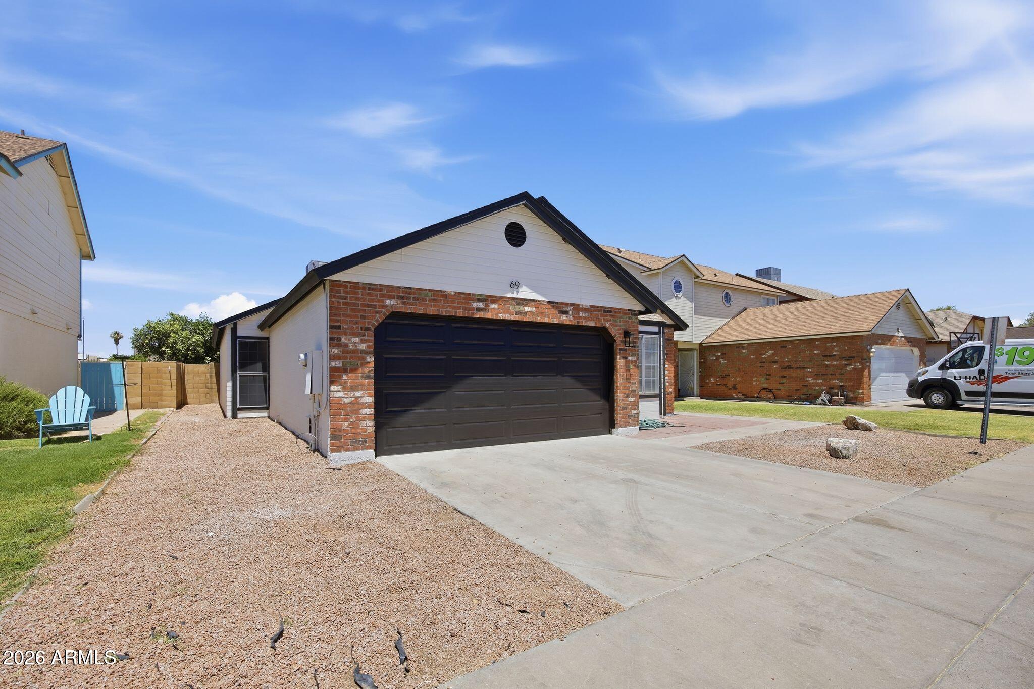 3134 East McKellips Road, Unit 69 Mesa, AZ 85213 - Photo 3 of 24 a front view of a house with a yard and garage