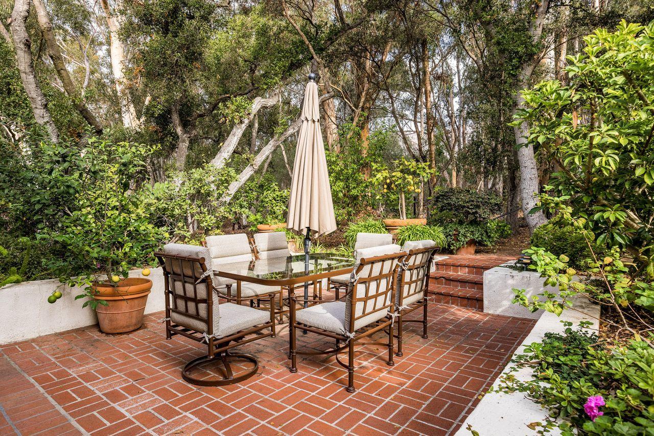 492 Monarch Lane Montecito, CA 93108 - Photo 40 of 58 a view of a patio with table and chairs and potted plants