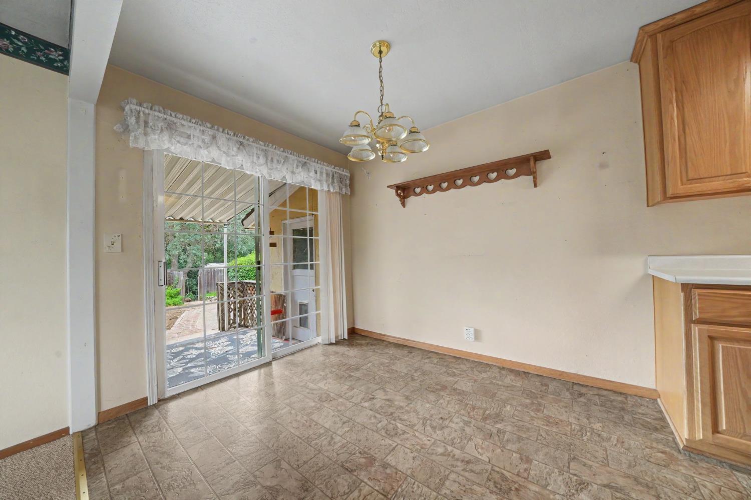 626 Sutter Lane Ione, CA 95640 - Photo 7 of 21 wooden floor in an empty room with a window