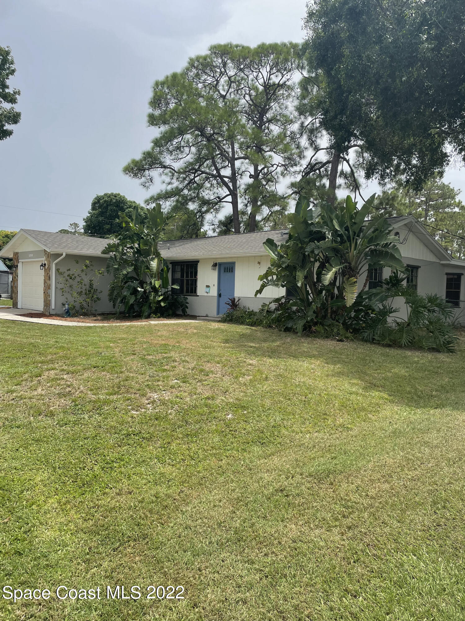 590 Rheine Road Northwest Palm Bay, FL 32907 - Photo 1 of 19 a view of house with yard