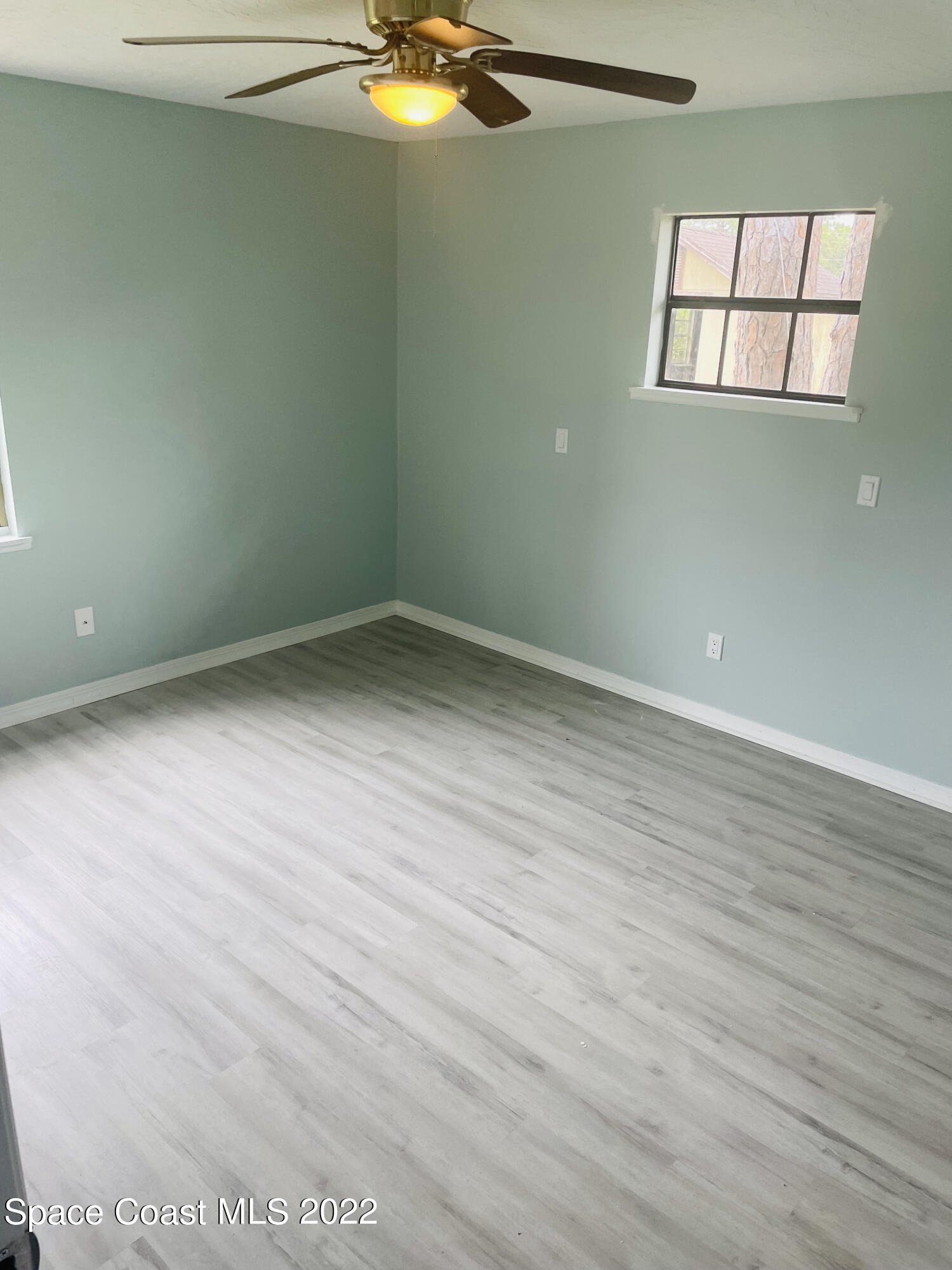 590 Rheine Road Northwest Palm Bay, FL 32907 - Photo 9 of 19 a view of empty room with wooden floor
