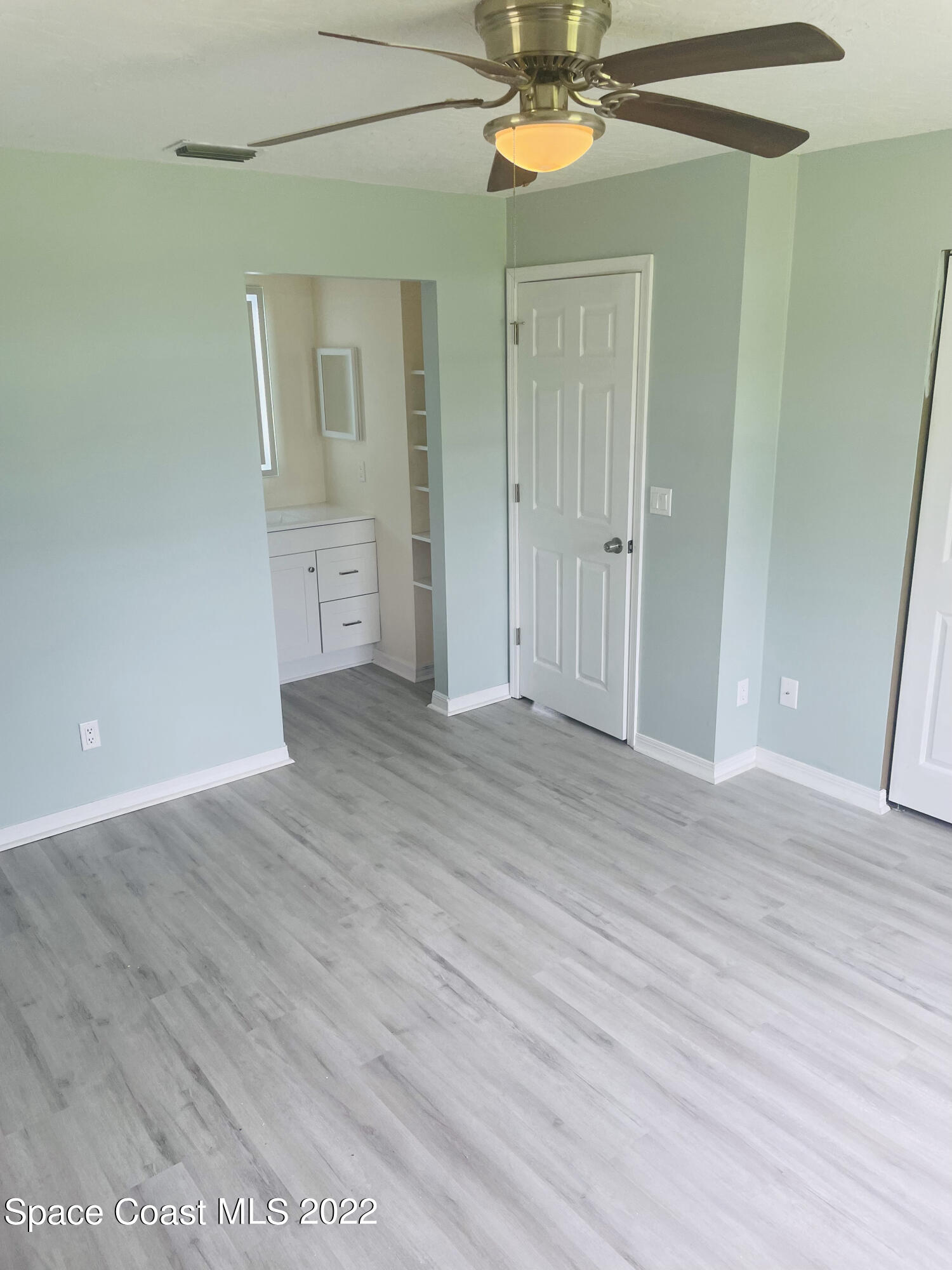 590 Rheine Road Northwest Palm Bay, FL 32907 - Photo 10 of 19 wooden floor in an empty room
