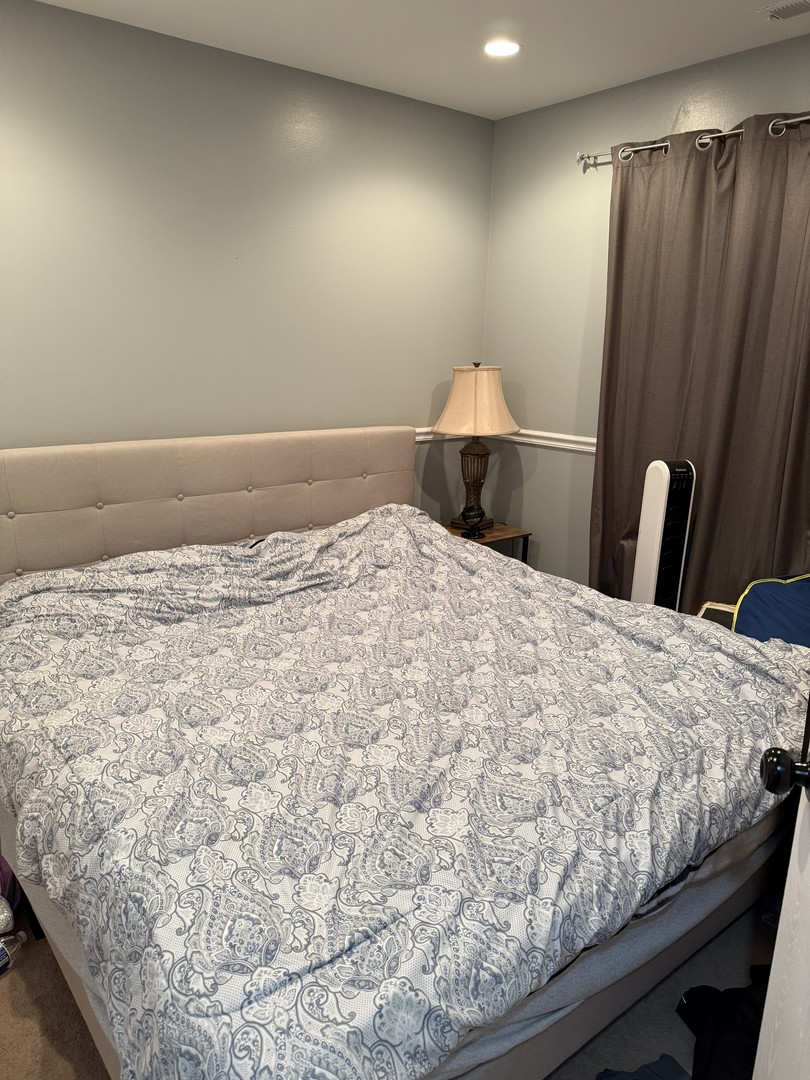 689 Shannon Drive Romeoville, IL 60446 - Photo 13 of 24 a bedroom with a bed and mirror