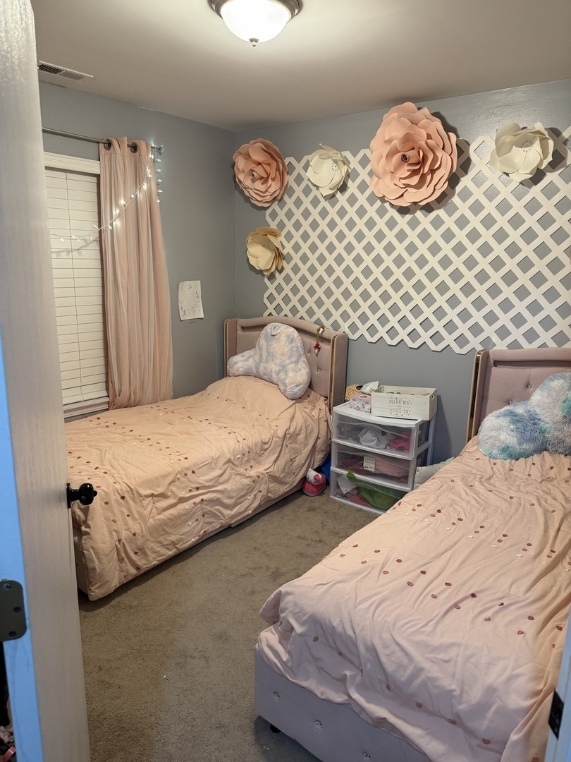 689 Shannon Drive Romeoville, IL 60446 - Photo 16 of 24 a bedroom with bed and dresser