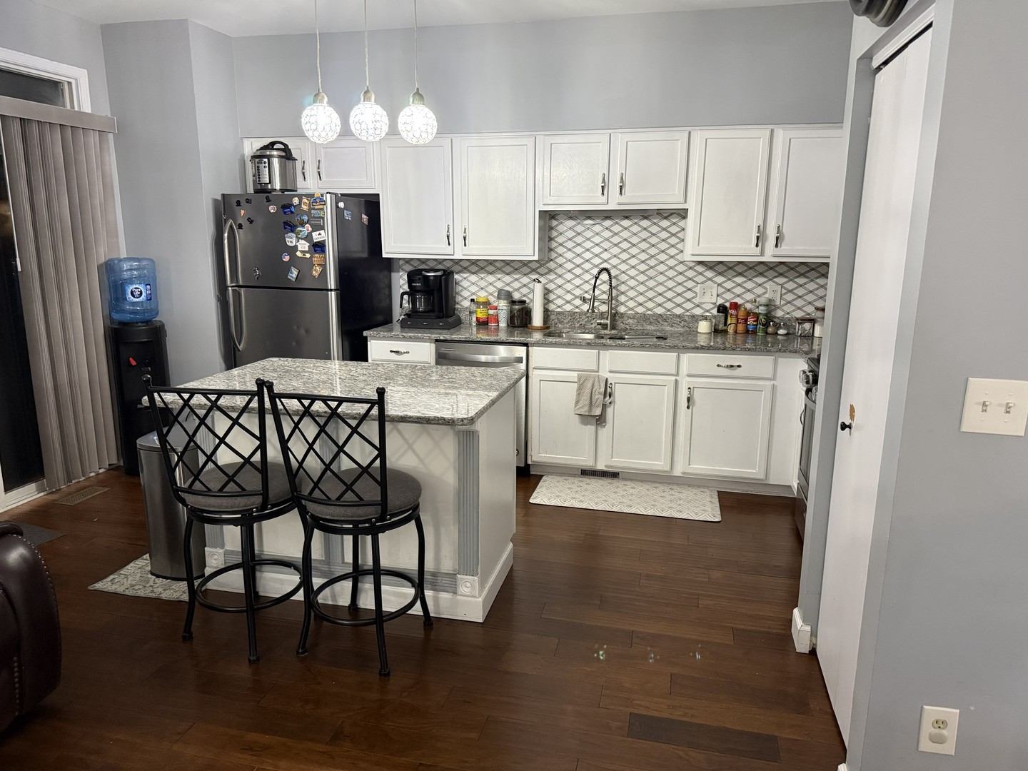 689 Shannon Drive Romeoville, IL 60446 - Photo 6 of 24 a kitchen with stainless steel appliances granite countertop a dining table chairs refrigerator and microwave