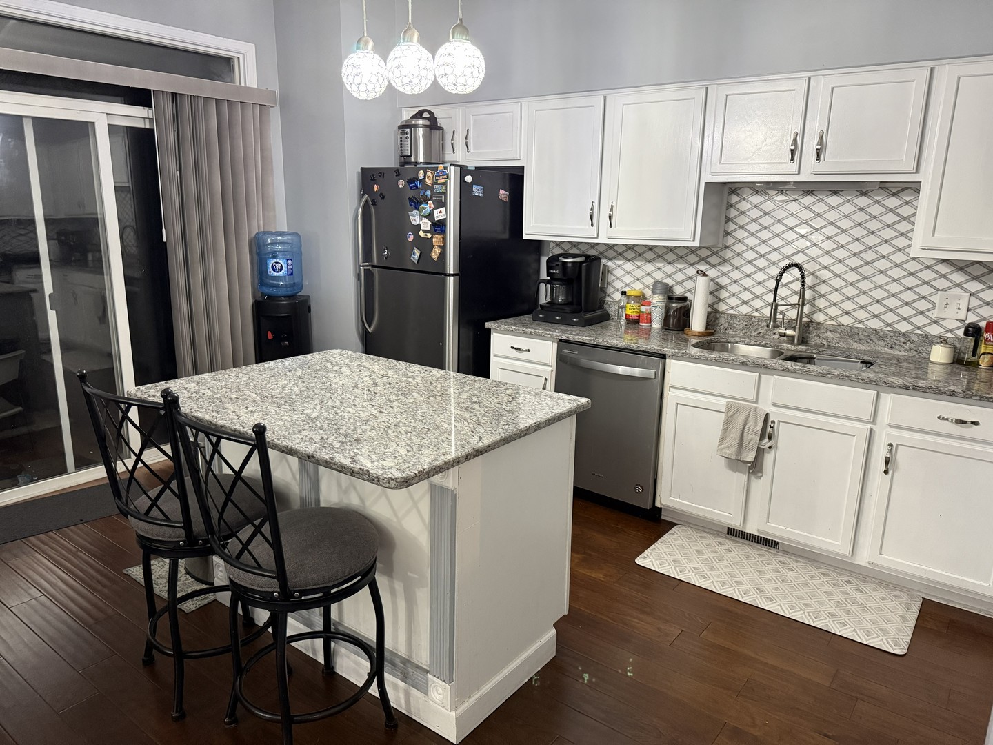 689 Shannon Drive Romeoville, IL 60446 - Photo 7 of 24 a kitchen with stainless steel appliances granite countertop a dining table chairs refrigerator and sink