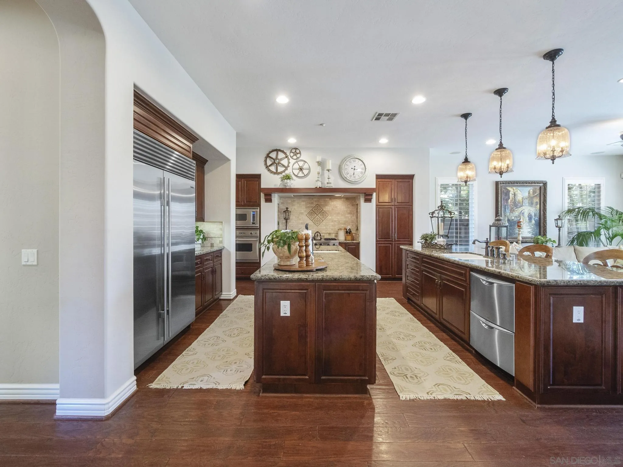 14636 Rio Rancho San Diego, CA 92127 - Photo 19 of 61 a large kitchen with kitchen island granite countertop a large counter top stainless steel appliances and cabinets
