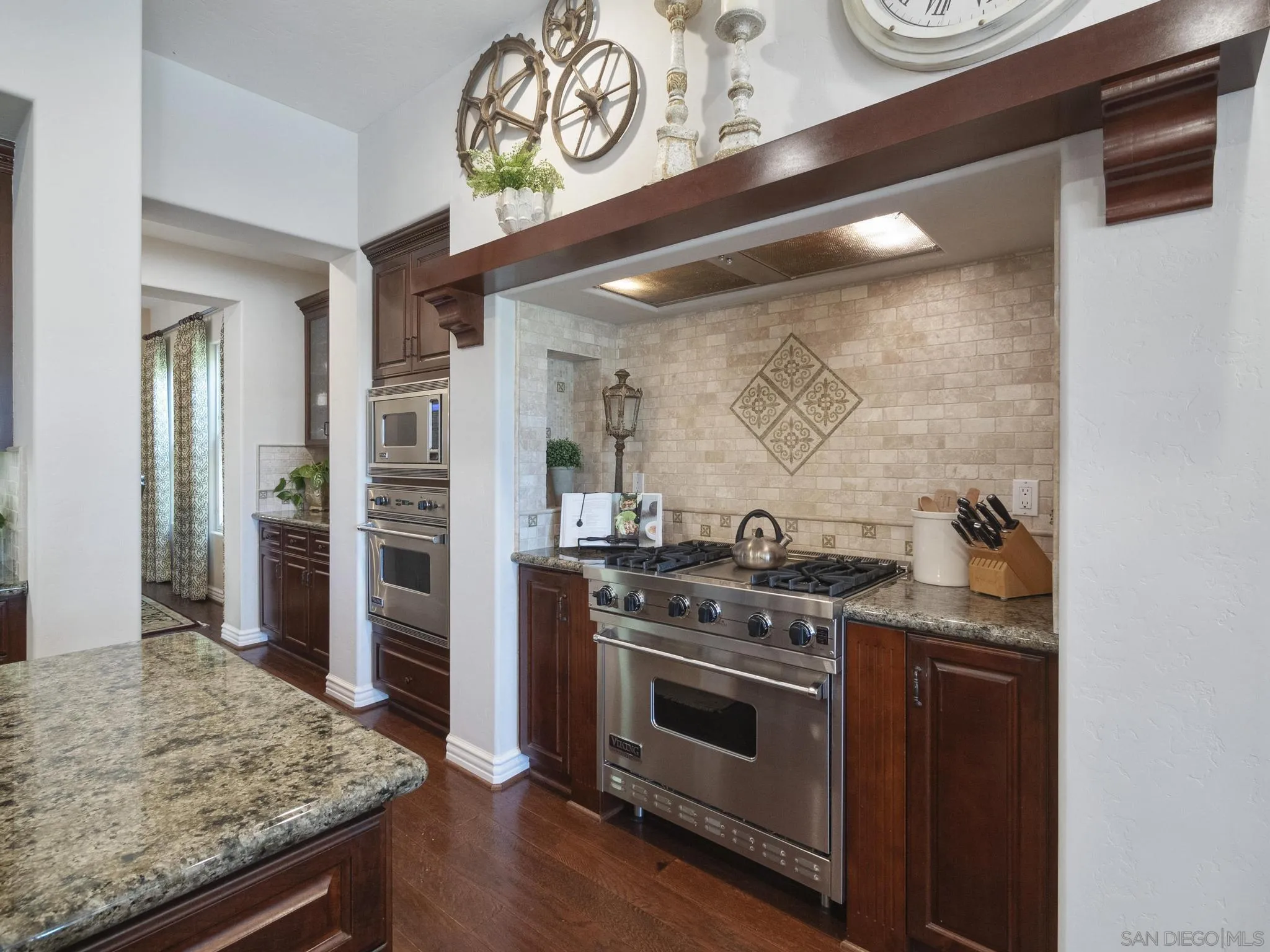 14636 Rio Rancho San Diego, CA 92127 - Photo 21 of 61 a kitchen with stainless steel appliances granite countertop a stove and a refrigerator