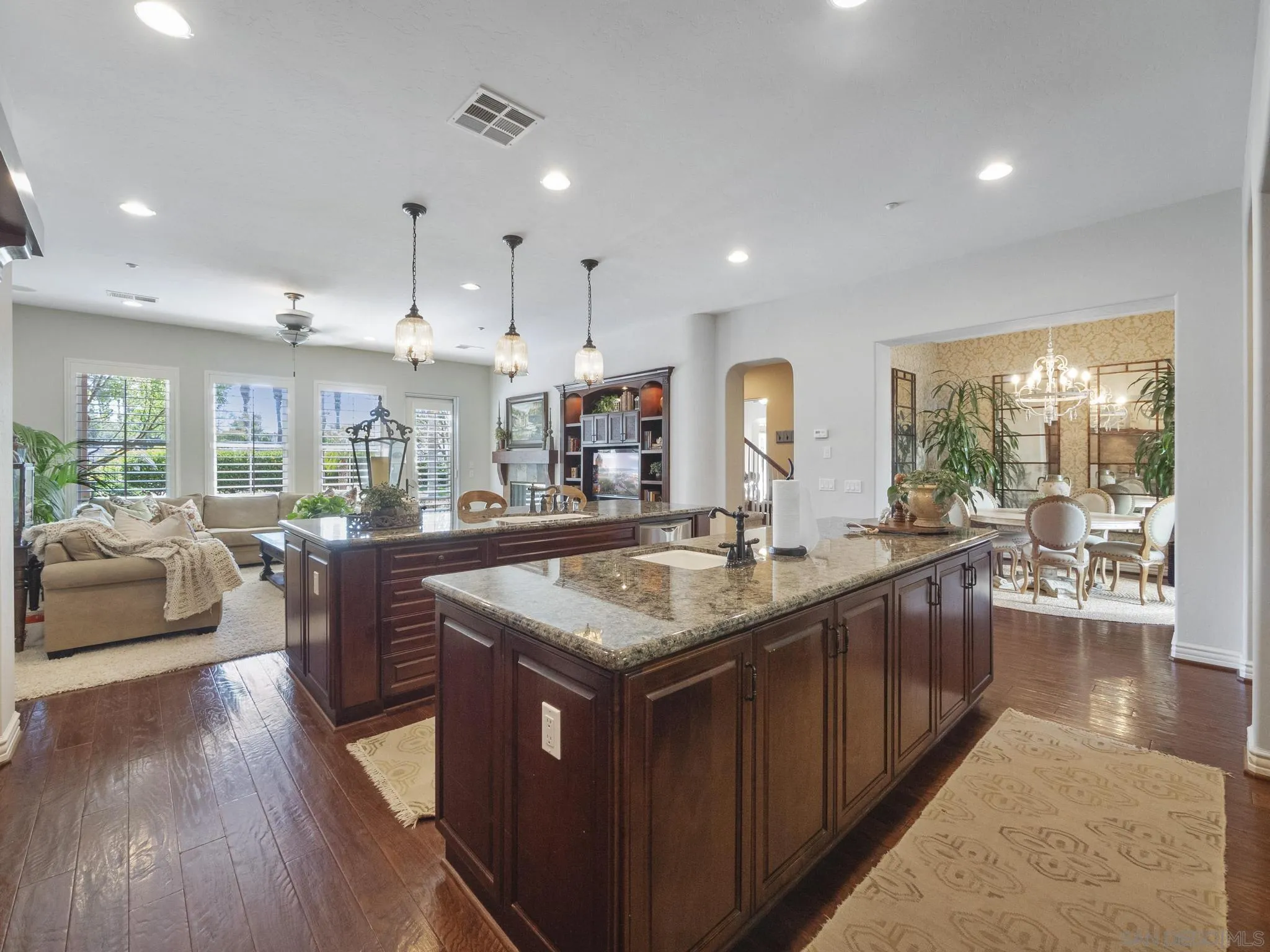 14636 Rio Rancho San Diego, CA 92127 - Photo 22 of 61 a kitchen with stainless steel appliances granite countertop sink stove and wooden floor