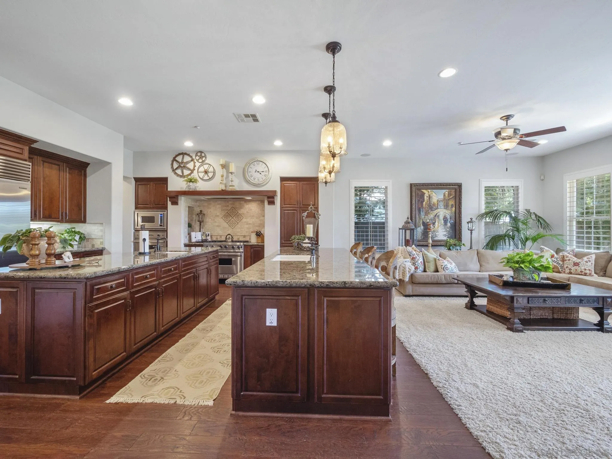 14636 Rio Rancho San Diego, CA 92127 - Photo 24 of 61 a large kitchen with kitchen island a large counter top space a sink a window and stainless steel appliances
