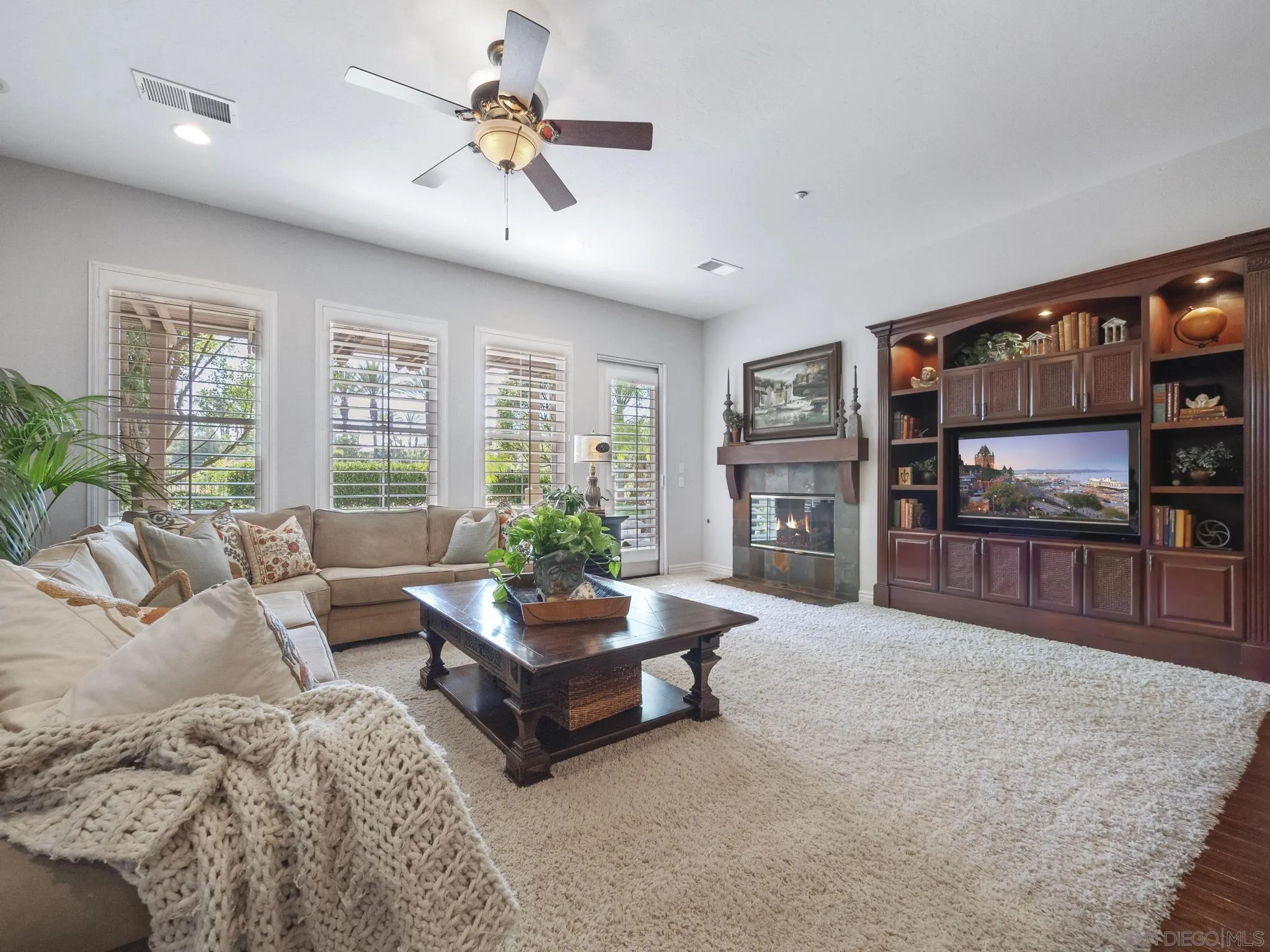 14636 Rio Rancho San Diego, CA 92127 - Photo 26 of 61 a living room with fireplace furniture and a flat screen tv