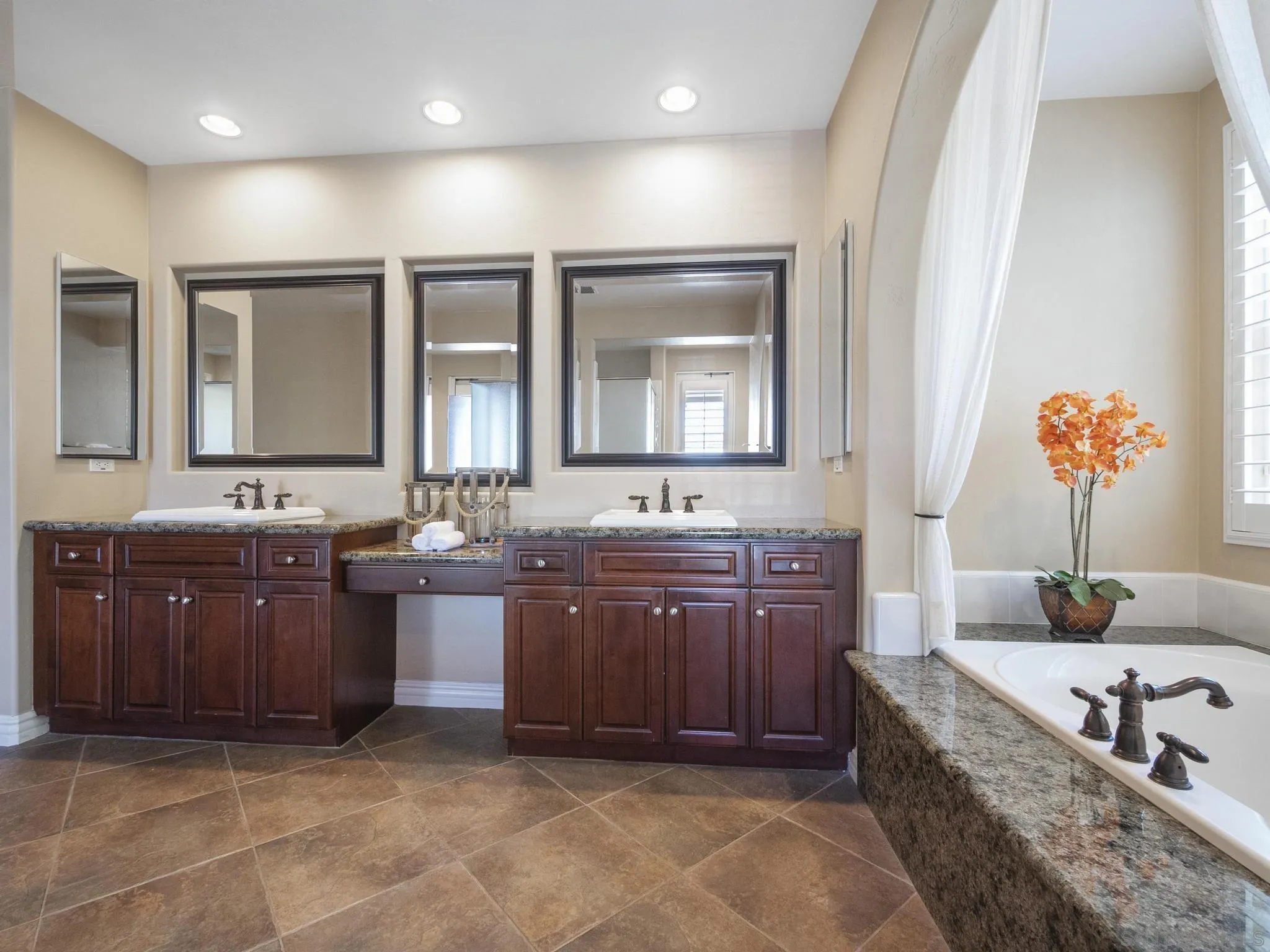 14636 Rio Rancho San Diego, CA 92127 - Photo 44 of 61 a spacious bathroom with a granite countertop tub sink and mirror