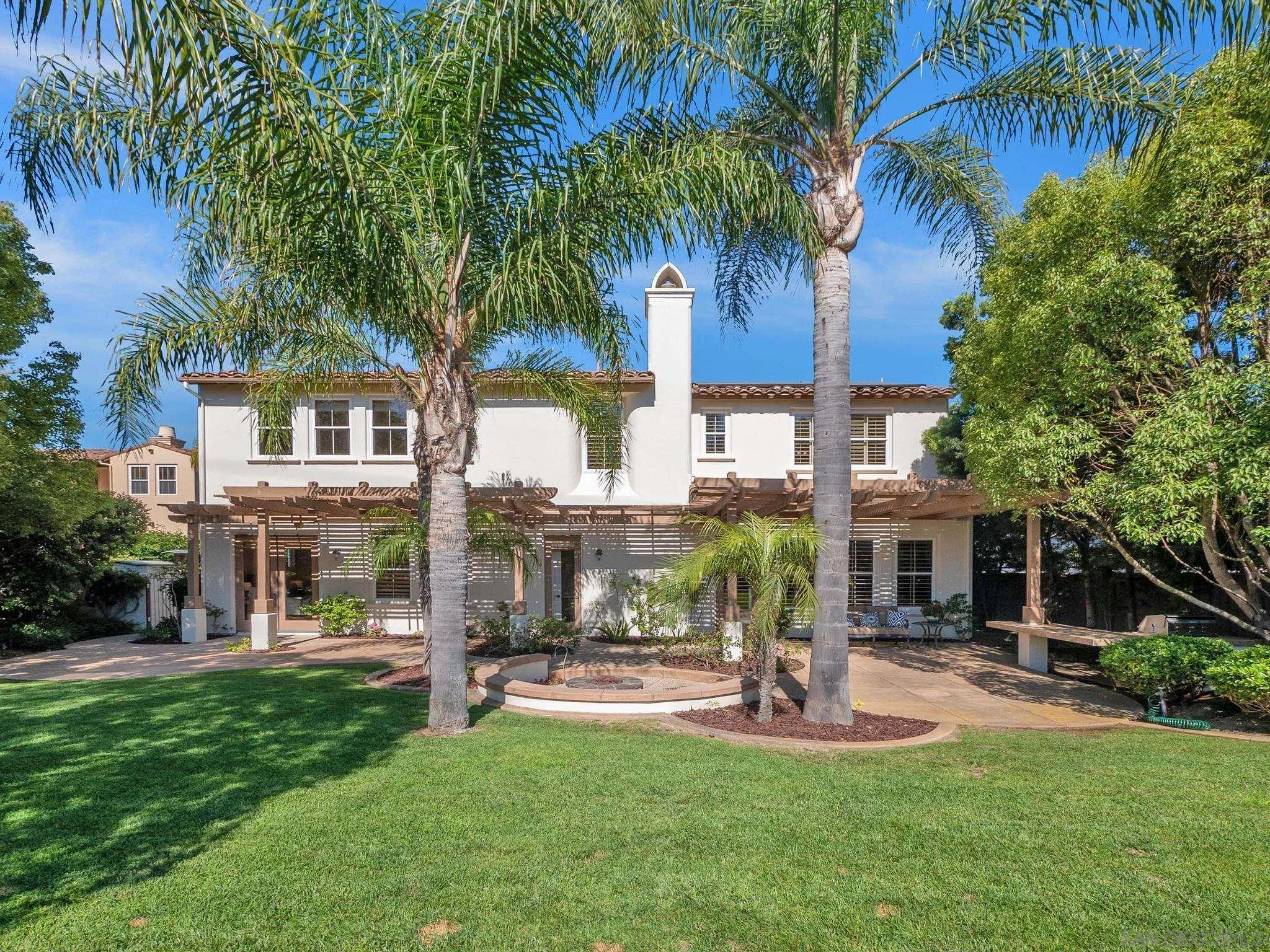 14636 Rio Rancho San Diego, CA 92127 - Photo 59 of 61 a front view of a house with a garden and palm trees