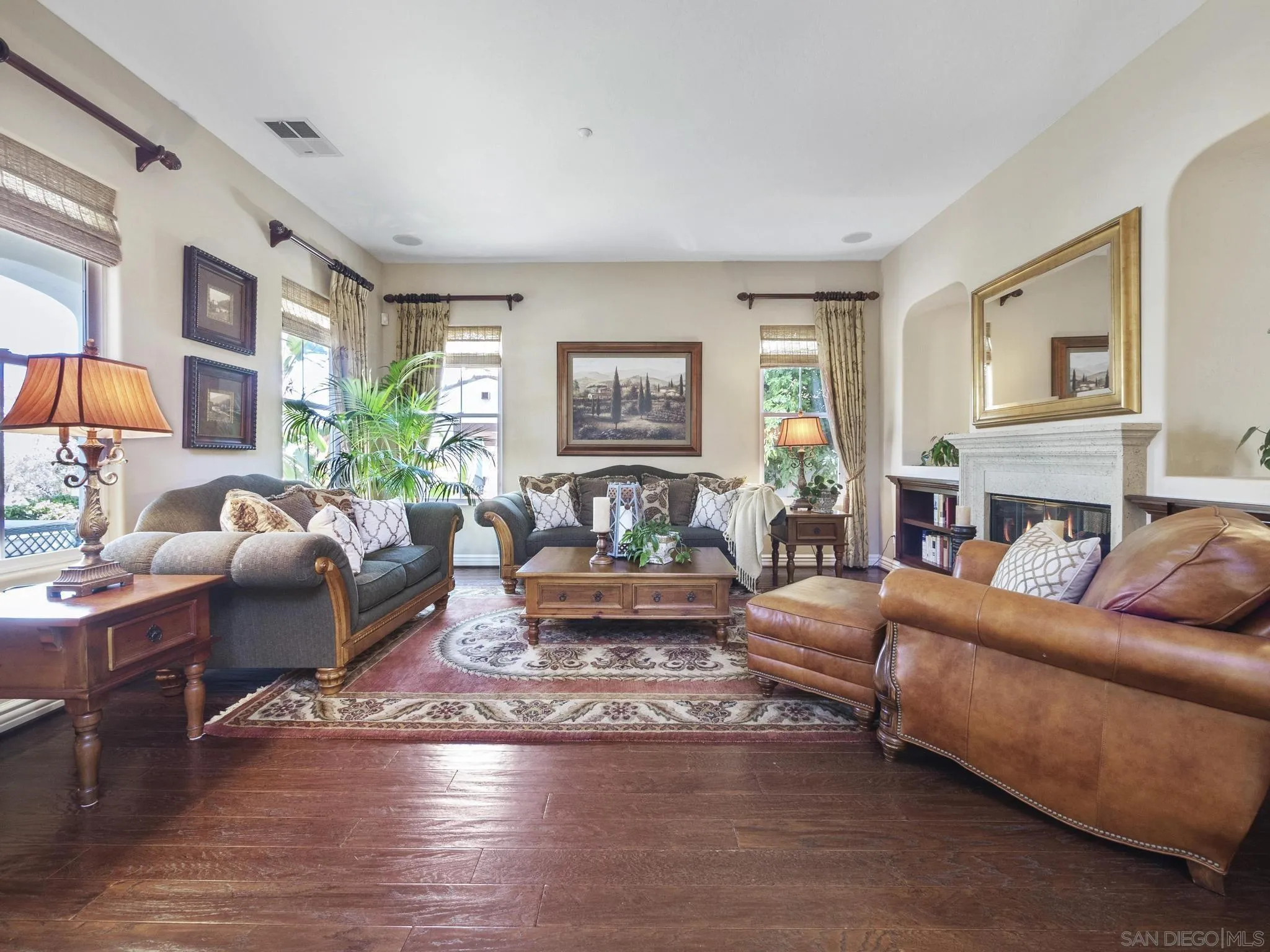 14636 Rio Rancho San Diego, CA 92127 - Photo 10 of 61 a living room with fireplace furniture and a wooden floor