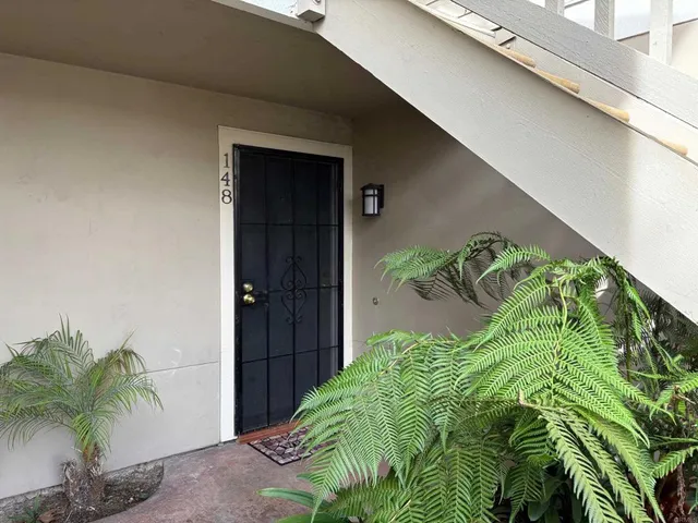 a picture of a plant in front of a door