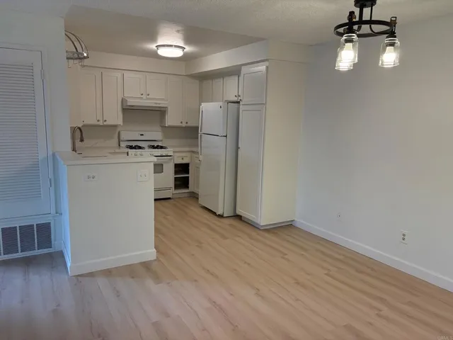 a kitchen with stainless steel appliances a refrigerator sink and microwave