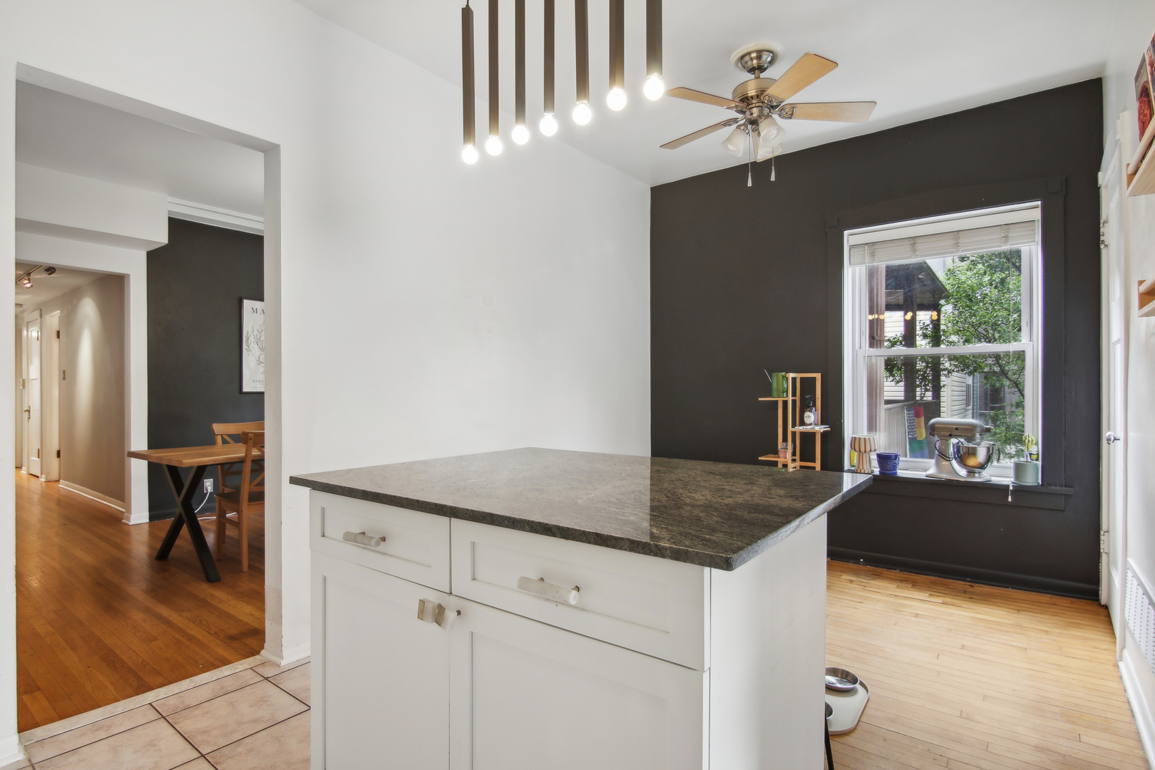 5683 North Ridge Avenue, Unit 2W Chicago, IL 60660 - Photo 14 of 23 a en suite bathroom with a granite countertop sink and a mirror