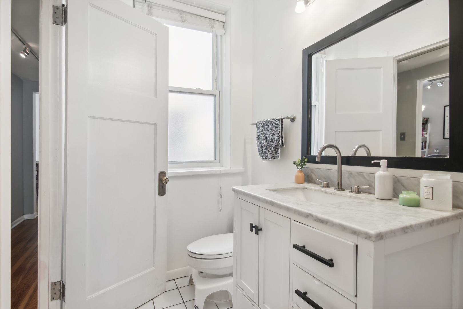 5683 North Ridge Avenue, Unit 2W Chicago, IL 60660 - Photo 17 of 23 a bathroom with a sink toilet vanity and mirror