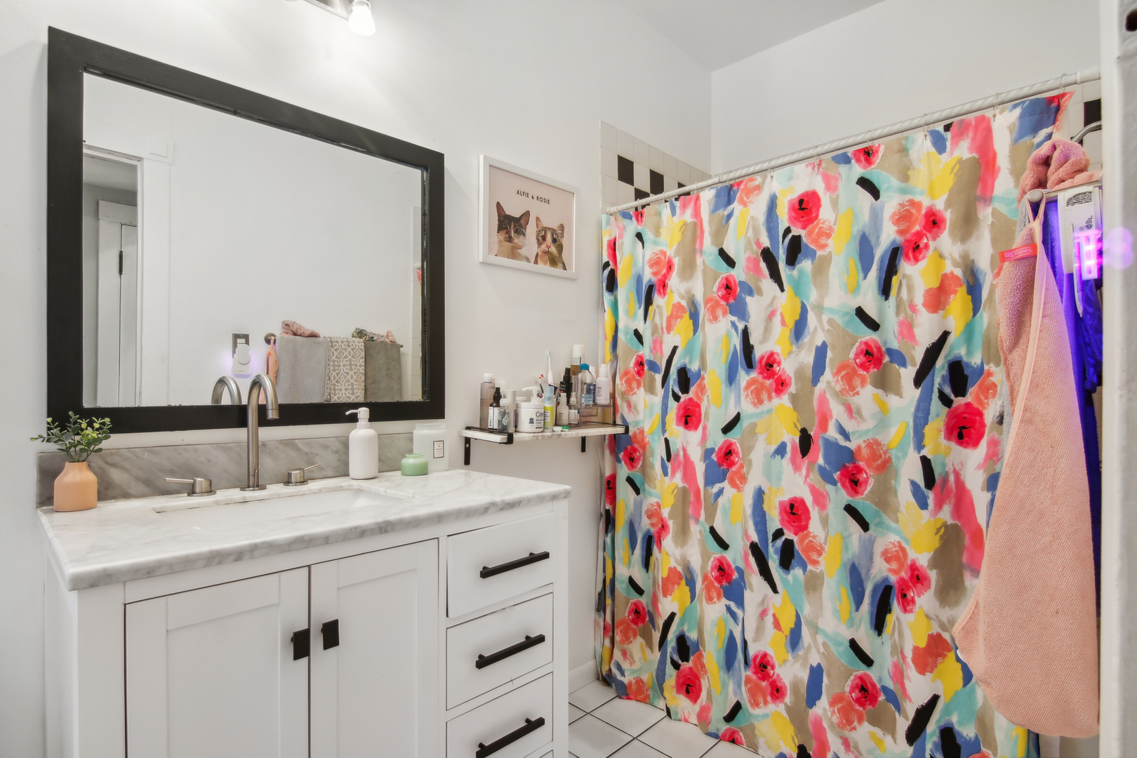 5683 North Ridge Avenue, Unit 2W Chicago, IL 60660 - Photo 18 of 23 a bathroom with a sink a mirror and shower curtain