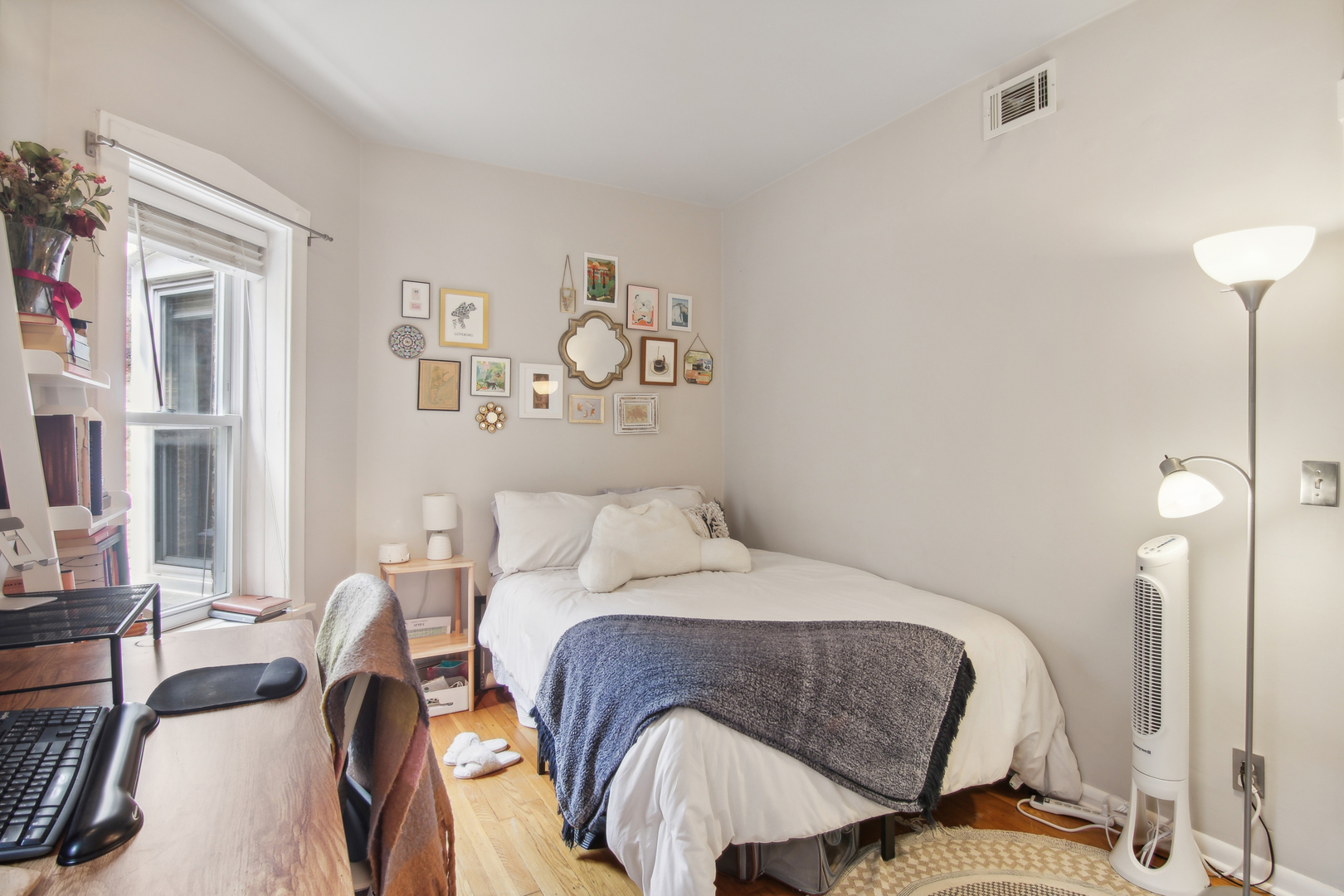 5683 North Ridge Avenue, Unit 2W Chicago, IL 60660 - Photo 19 of 23 a bedroom with a bed and wooden floor