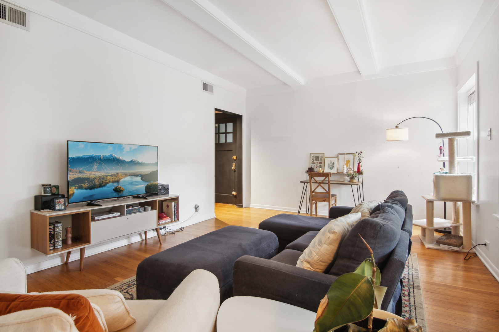 5683 North Ridge Avenue, Unit 2W Chicago, IL 60660 - Photo 7 of 23 a living room with furniture and a flat screen tv