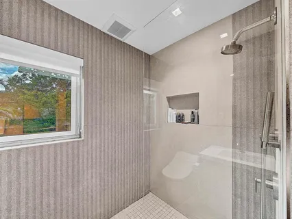 a bathroom with a bathtub and shower