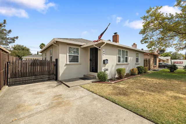 a front view of a house with a garden