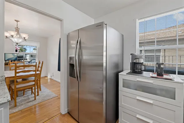 a kitchen with a refrigerator and furniture