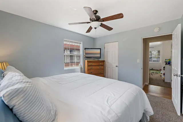 a bedroom with a large bed and a chandelier