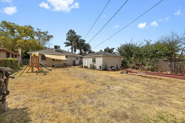 a yellow house with trees in front of it