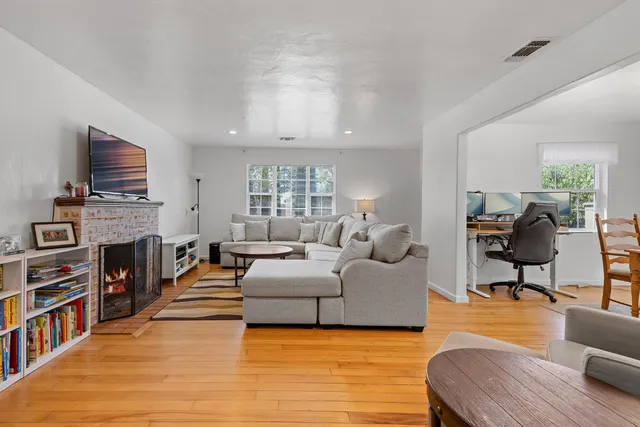 a living room with fireplace furniture and a flat screen tv