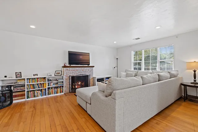 a living room with furniture a fireplace and a flat screen tv
