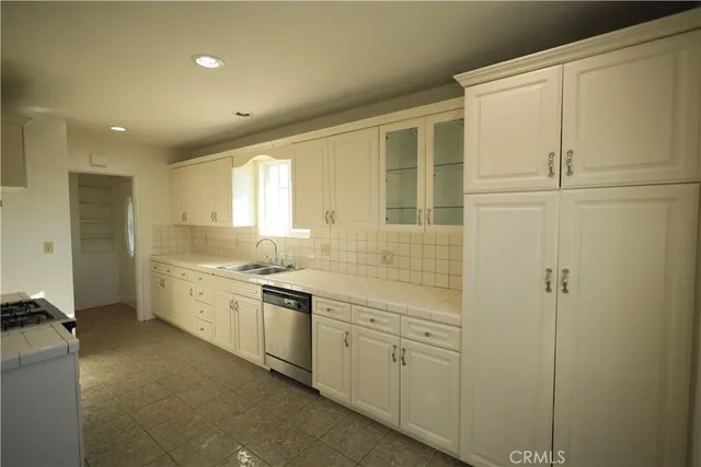 a large bathroom with a double vanity sink a mirror and a shower