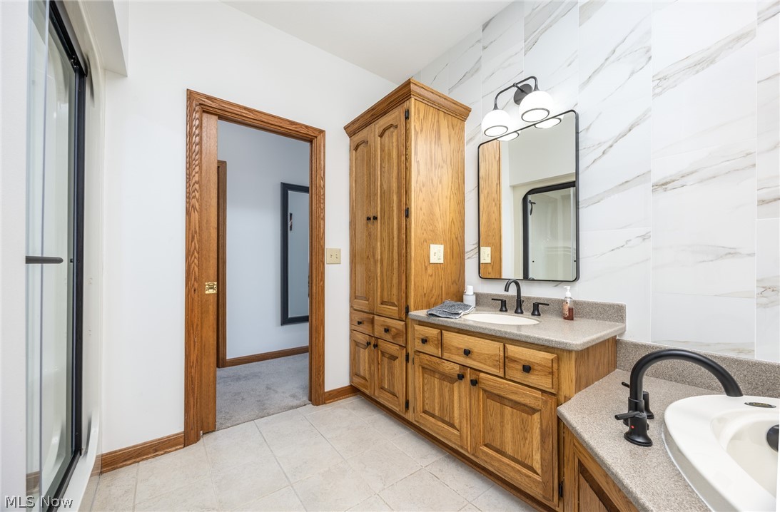 1602 Glendale Road, Unit 3 Marietta, OH 45750 - Photo 23 of 49 Bathroom featuring dual wood-finish vanities with composite countertops and matte black fixtures