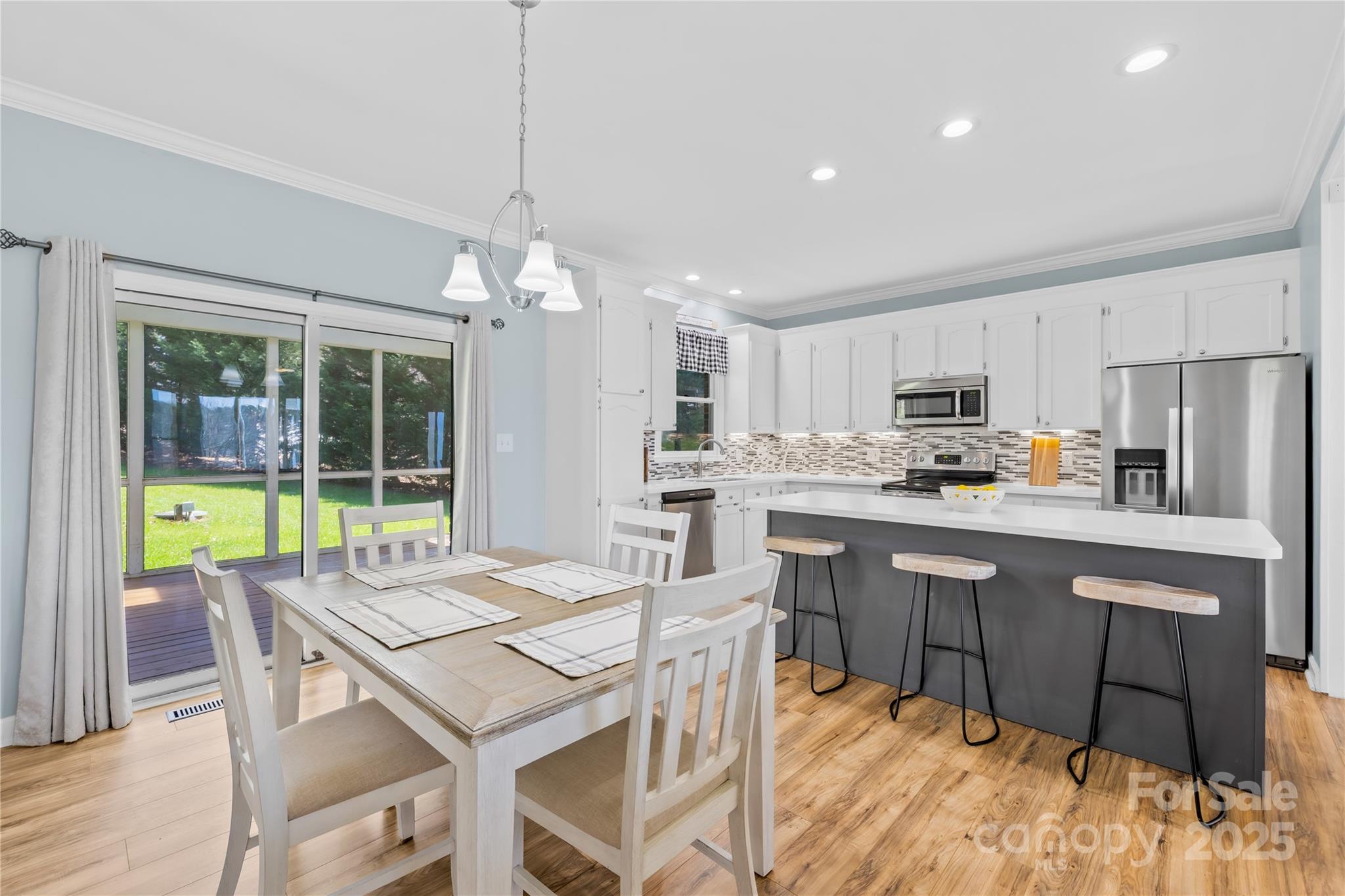 675 Normandy Road Mooresville, NC 28117 - Photo 14 of 36 a kitchen with kitchen island a dining table and chairs