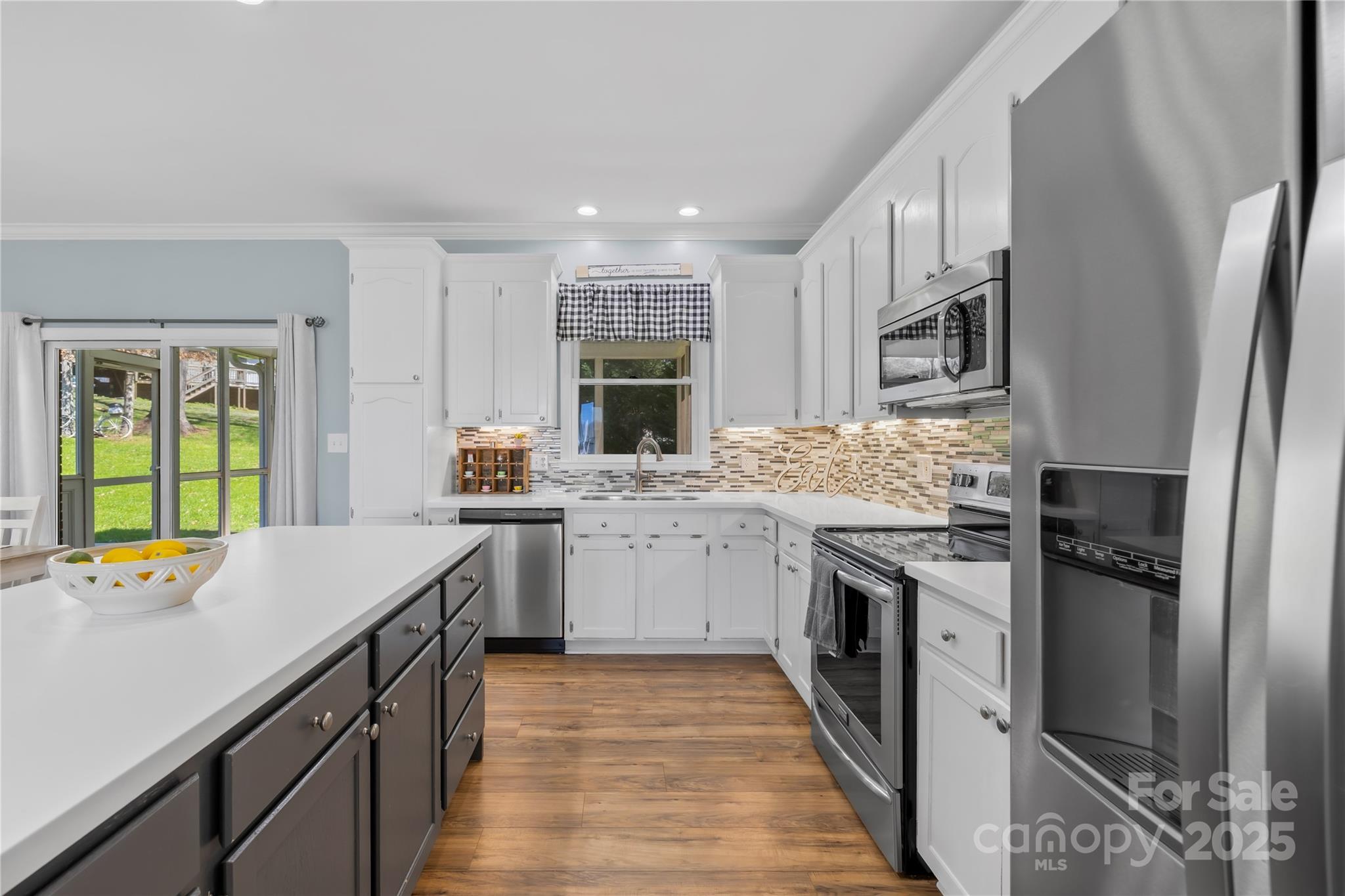 675 Normandy Road Mooresville, NC 28117 - Photo 17 of 36 a kitchen with a sink stove and refrigerator