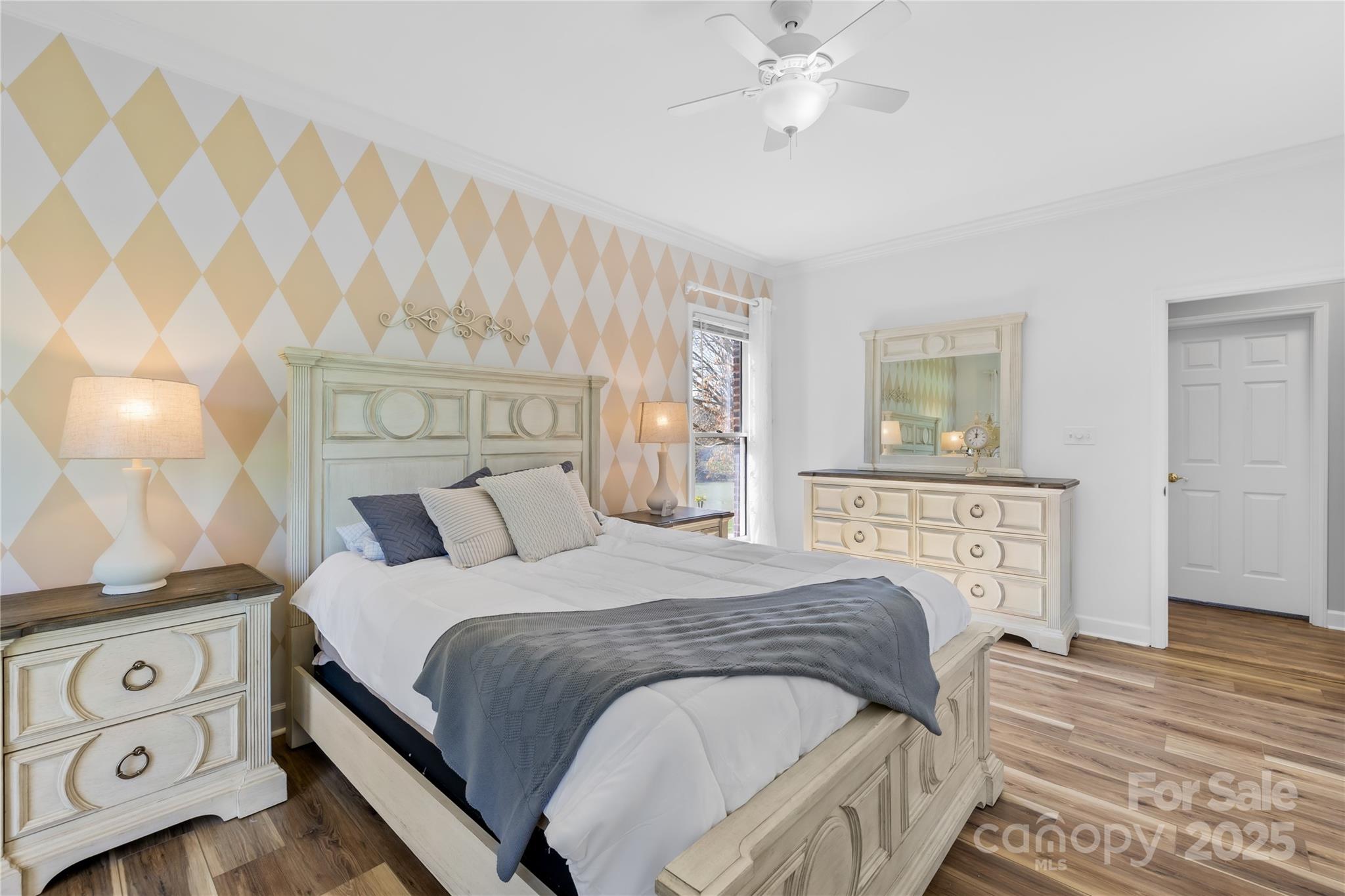 675 Normandy Road Mooresville, NC 28117 - Photo 24 of 36 a bedroom with a bed and a chandelier