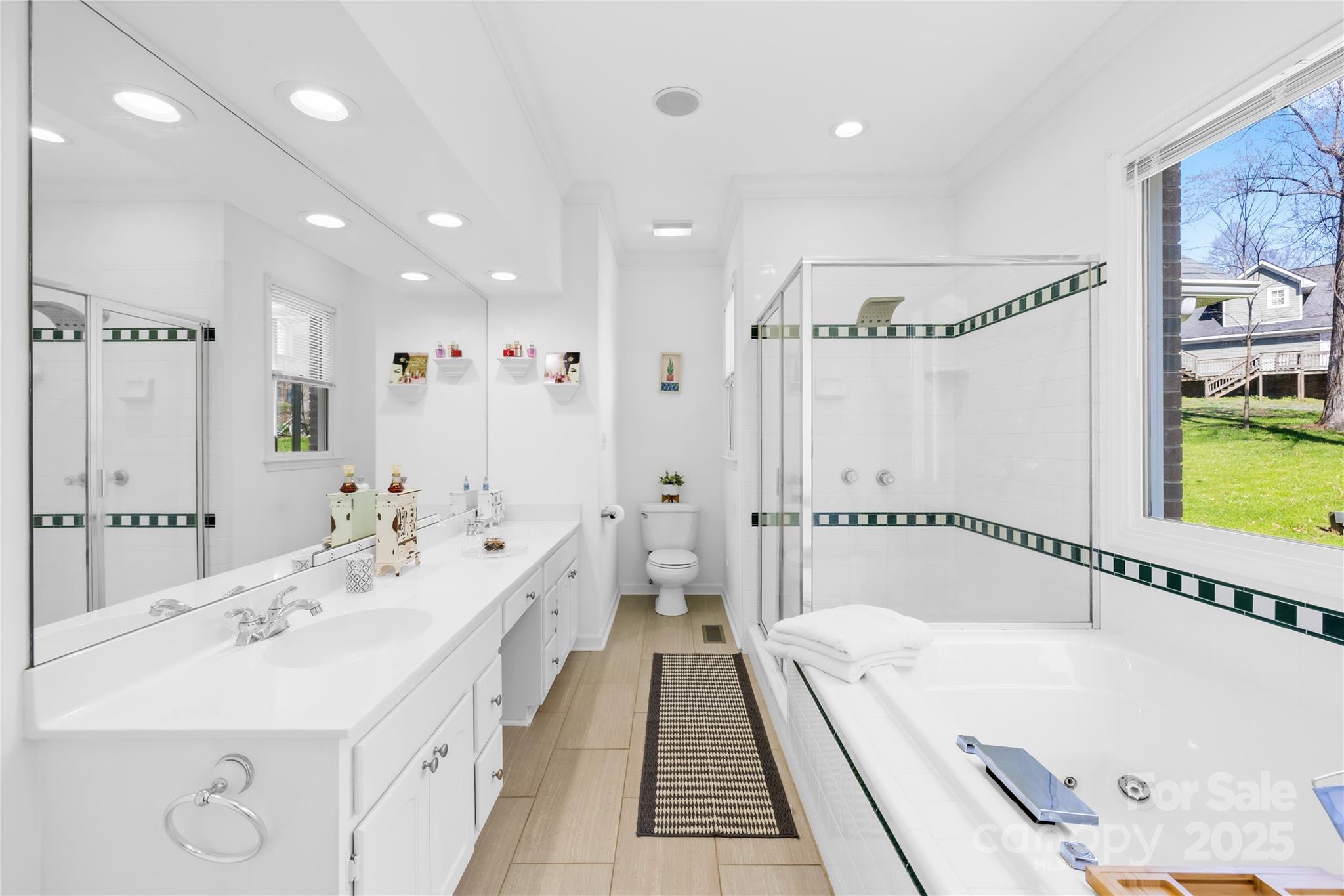 675 Normandy Road Mooresville, NC 28117 - Photo 27 of 36 a spacious bathroom with a double vanity sink and a bathtub