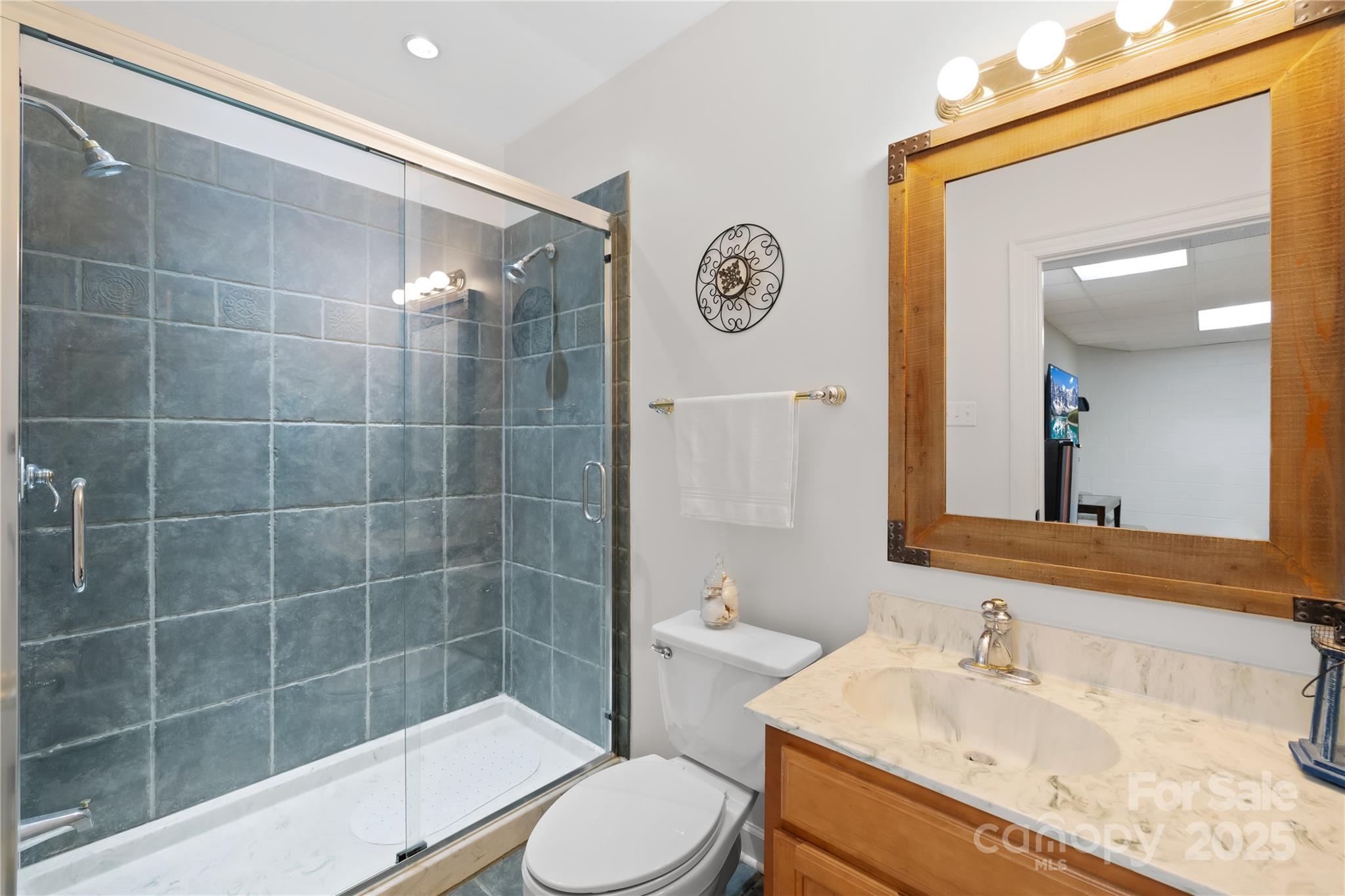 675 Normandy Road Mooresville, NC 28117 - Photo 32 of 36 a bathroom with a sink a toilet and shower