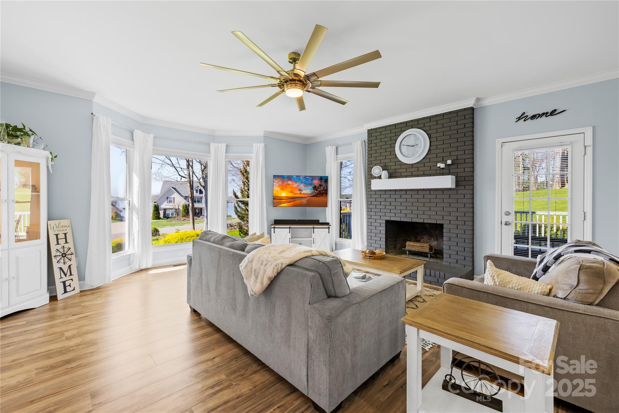 675 Normandy Road Mooresville, NC 28117 - Photo 8 of 36 a living room with furniture a fireplace and a flat screen tv
