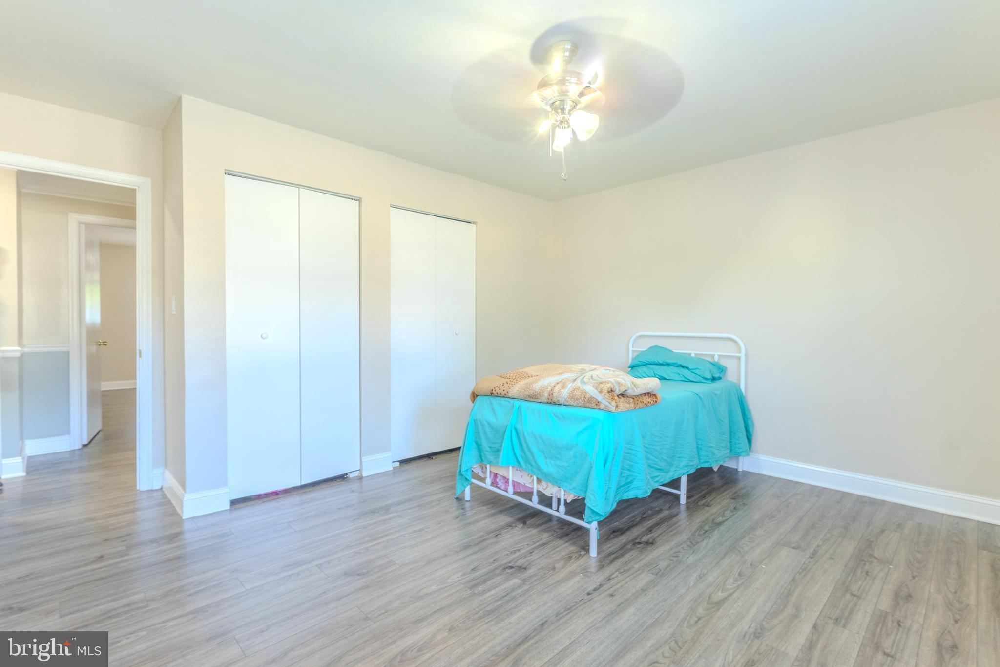 2106 North Rolling Road Windsor Mill, MD 21244 - Photo 19 of 26 a room with a bed and a table