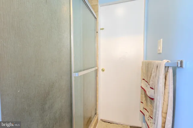 a bathroom with a shower and a mirror