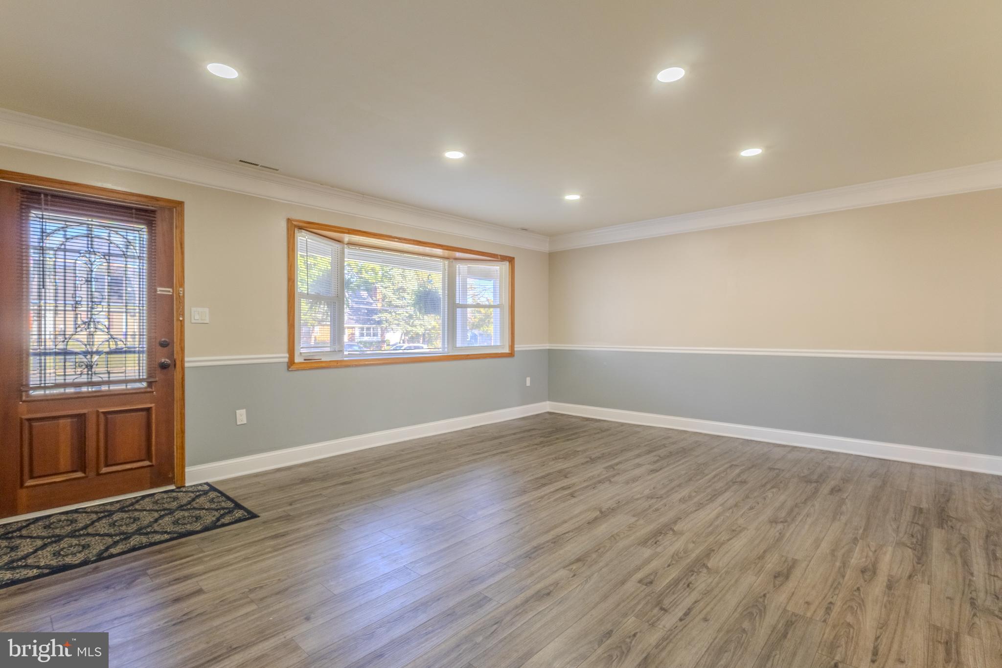 2106 North Rolling Road Windsor Mill, MD 21244 - Photo 6 of 26 an empty room with wooden floor and windows