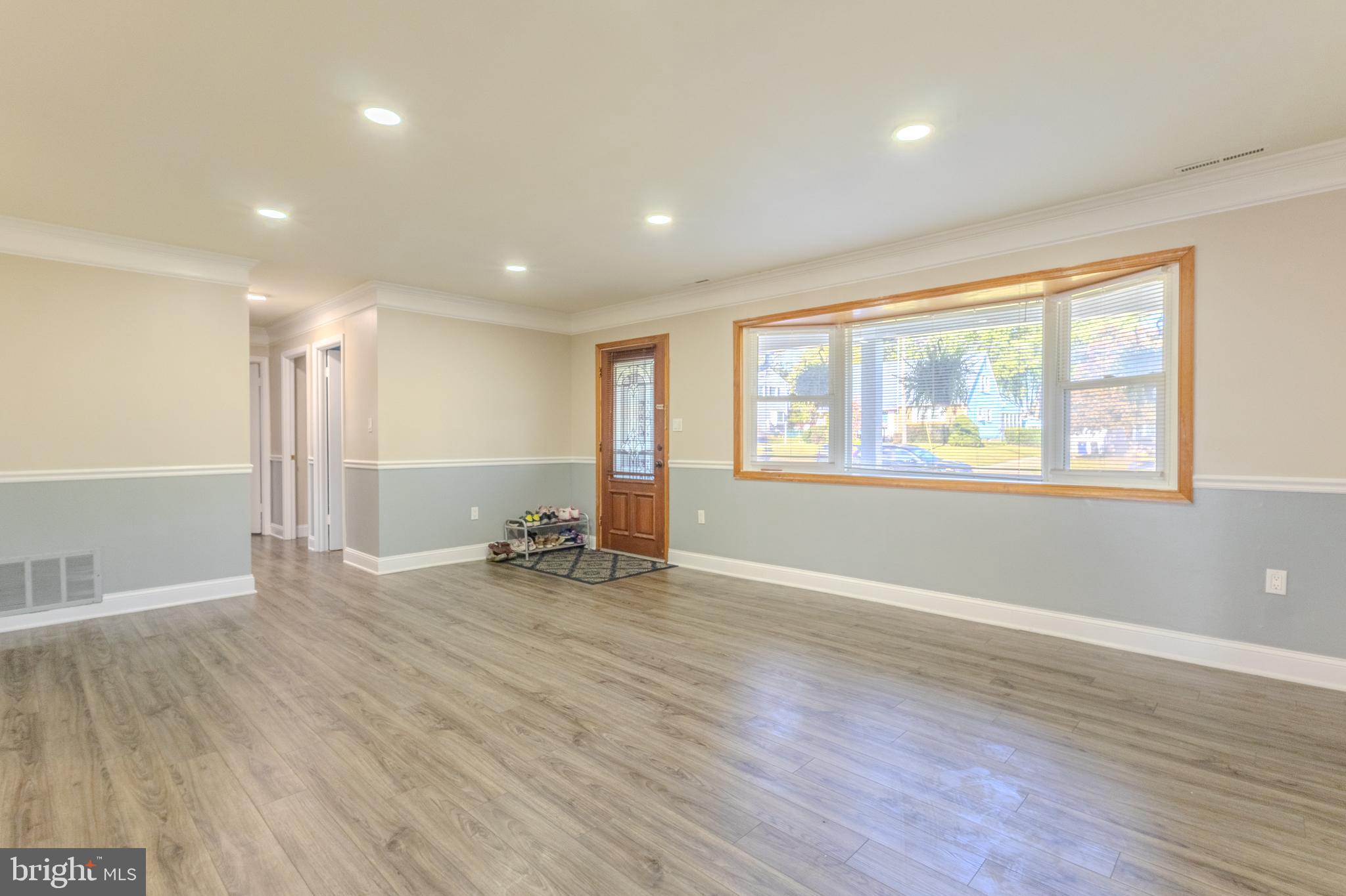 2106 North Rolling Road Windsor Mill, MD 21244 - Photo 7 of 26 a view of an empty room with window and wooden floor