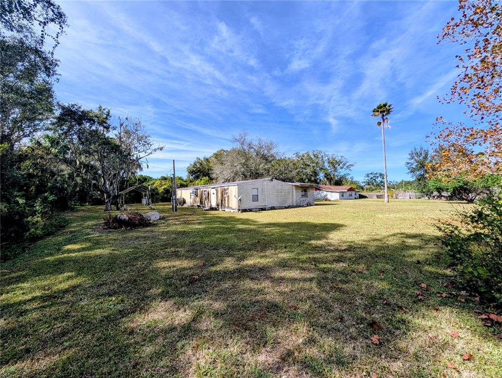 8412 Peterson Road Odessa, FL 33556 - Photo 3 of 10 a view of a garden with a building in the background